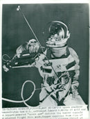 A space engineer demonstrates how astronaut Edward H. White II will use an "aerospace gun" with oxygen - Vintage Photograph