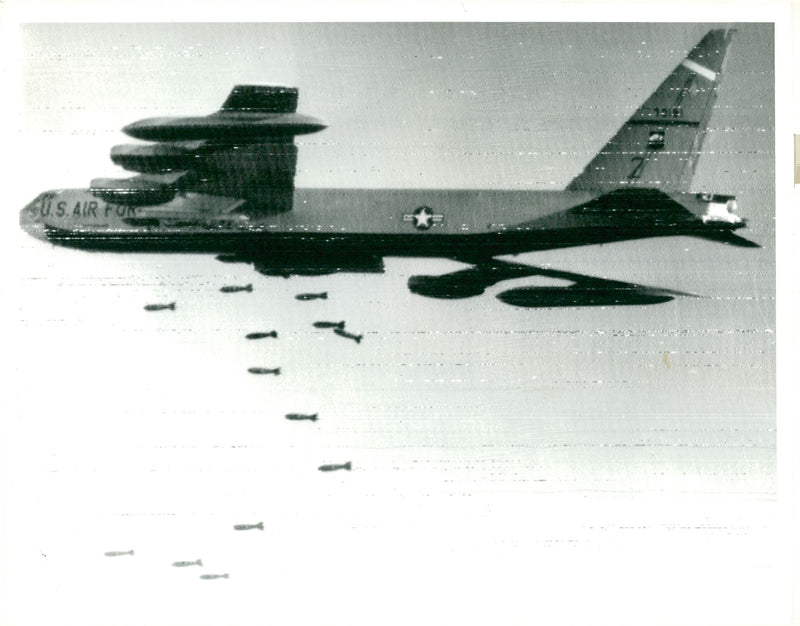 Pound bombs fall from their externally mounted. - Vintage Photograph