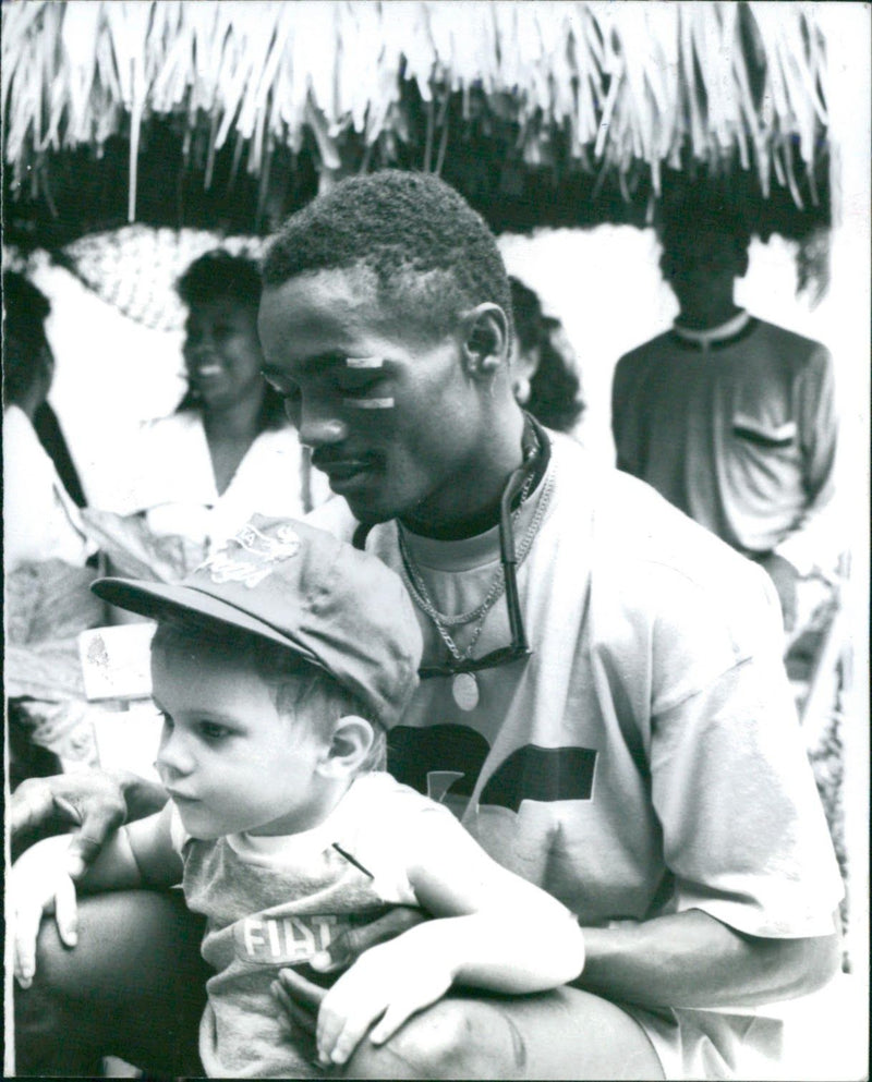 Boxer Elicier Julio sitting with a child - Vintage Photograph