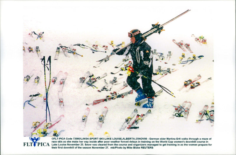 Martina Ertl walks through a maze of skis after the bad weather delays the World Cup training - Vintage Photograph