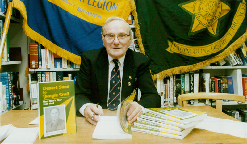 WWII veteran Bill Cooper signs his book at the Witney Library in Oxfordshire, England. - Vintage Photograph