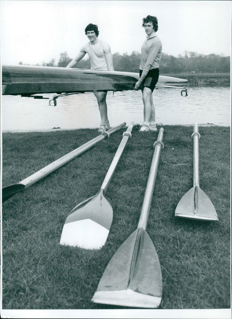 Abingdon Rowing Club members take out a boat after a training session and 11 year old Paul Simmonds takes control of the boat. - Vintage Photograph