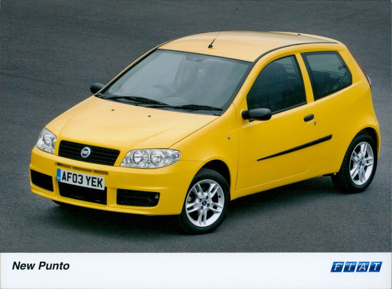 The new Fiat Punto is on display at a car showroom. - Vintage Photograph