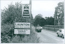 A sign reading "KILL YOUR SPEED" stands in a rural landscape in Launton, England. - Vintage Photograph