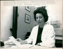 Dr Ann Robinson examines the blood of the late Mr Leslie Newson in her office at London Hospital Medical College. - Vintage Photograph