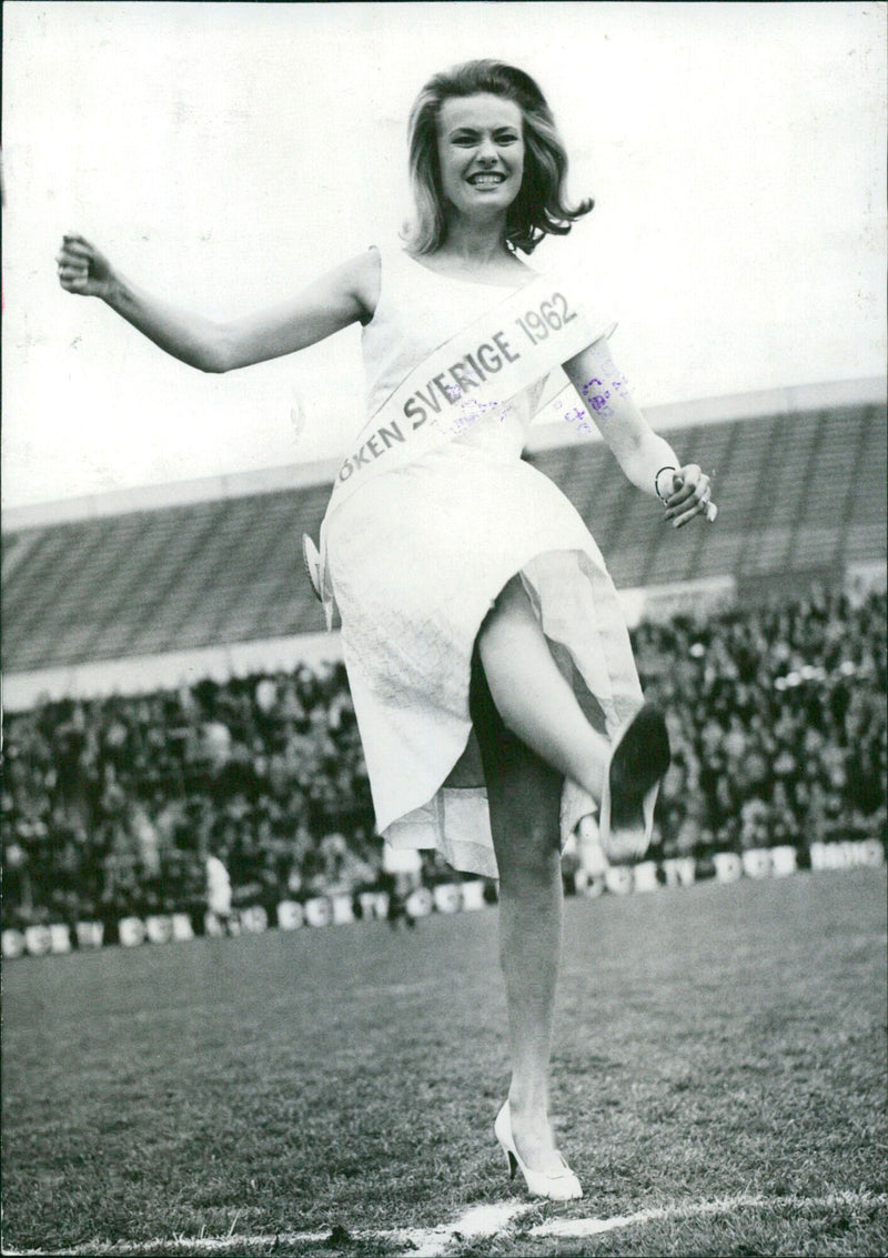 Miss Sweden 1962, Karin Hyldgaard-Jensen, kicks off a soccer match at Råsunda Stadium in Stockholm, Sweden on May 1, 1962. - Vintage Photograph