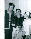 Chuck Connors, wife and daughter pose with actor Peter Falk in 1973. - Vintage Photograph
