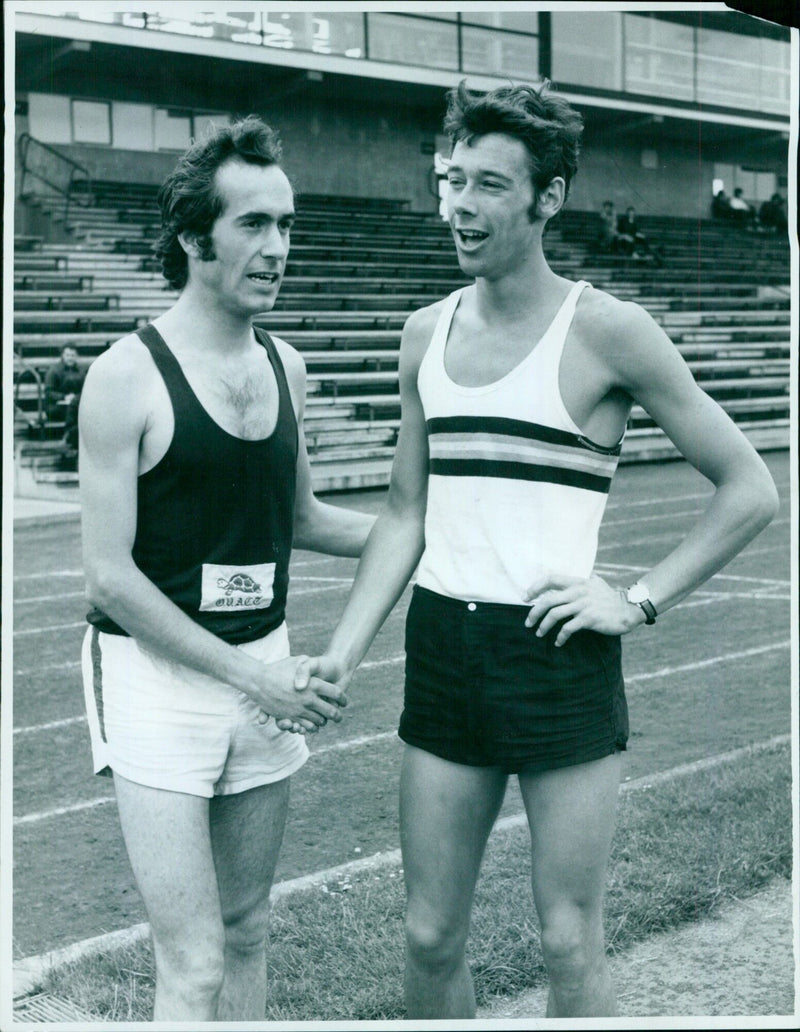 Richard Hartford of Pembroke College congratulates Edwin Oxlade of St. John's College after Oxlade won the one mile track event. - Vintage Photograph