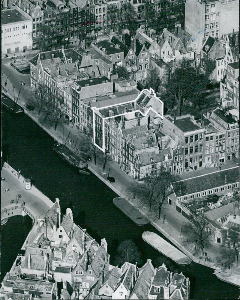 A historic view of the Prinsengracht house in Amsterdam, Netherlands, where Anne Frank hid during WWII and wrote her famous diary, depicted in a KLM aerial photograph taken in 1967. - Vintage Photograph