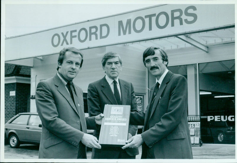 Ray Berrill, Service Manager of Oxford Motors, receives the Quality Service Award from Ron Collison, Zone Service Manager for Peugeot/Talbot. - Vintage Photograph