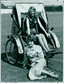 A four-wheel drive vehicle drives through a desert landscape. - Vintage Photograph