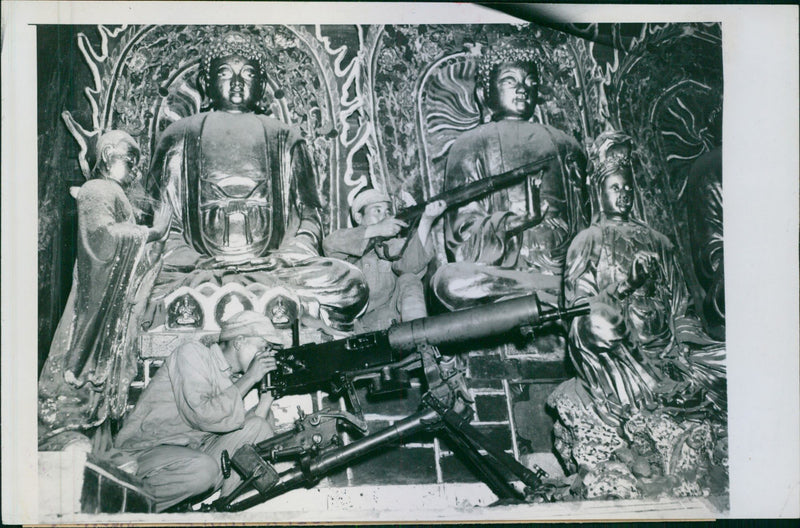 The bloody siege of Tengchung. Soldiers operating machine guns in n ancient Chinese temple. - Vintage Photograph
