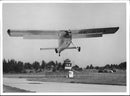 An Helio Courier plane at the airfield. - Vintage Photograph