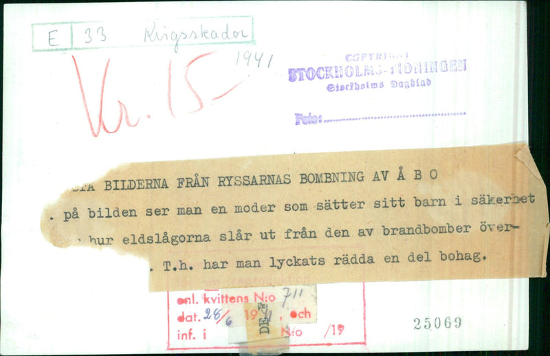 A mother shelters her child from the flames of a bombing raid in Åbo, Finland on 1941-11-15. Photo by Stockholms Dagblad/Stockholms-Tidningen. - Vintage Photograph