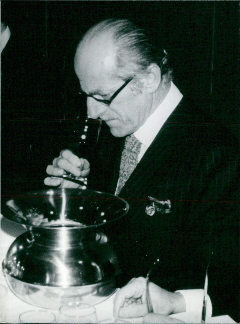 Baron Elie de Rothschild samples fine wines at a tasting in New York in 1917. - Vintage Photograph