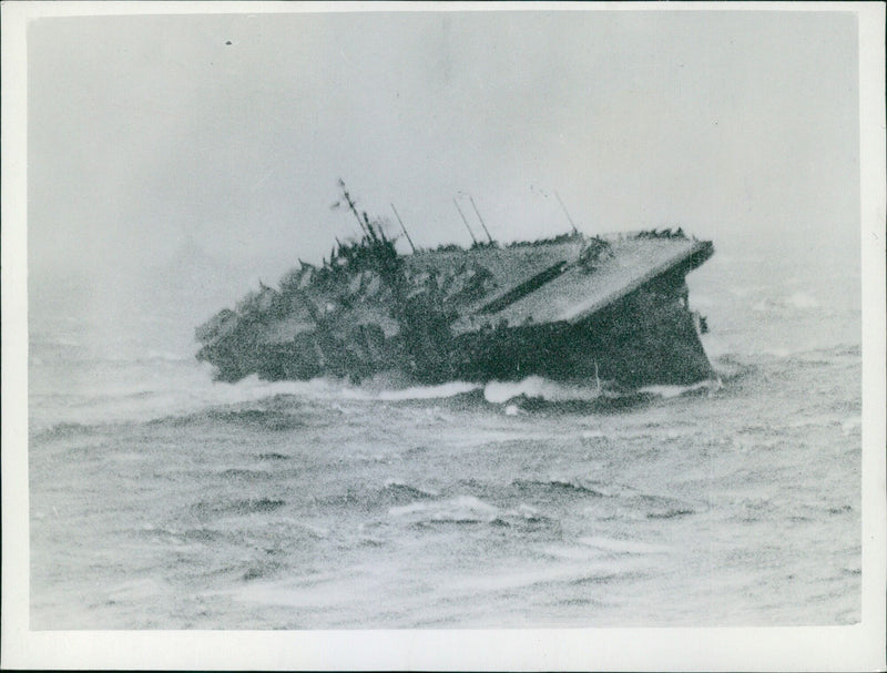 An aircraft carrier of the Essex class battles heavy seas in the Pacific Ocean on June 29th, 1945. - Vintage Photograph