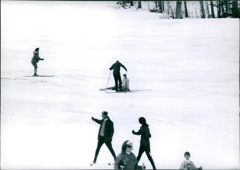 Mrs. John F. Kennedy and her two children share a light-hearted moment while skiing in Stowe, Vermont. - Vintage Photograph