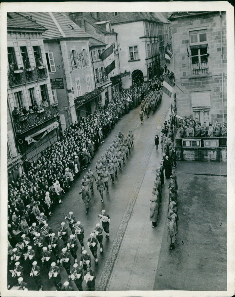 American and French soldiers march in review for Lieutenant General Alexander M. Patch during Armistice Day celebration in Luxeuil, France, honoring the last war's dead. - Vintage Photograph