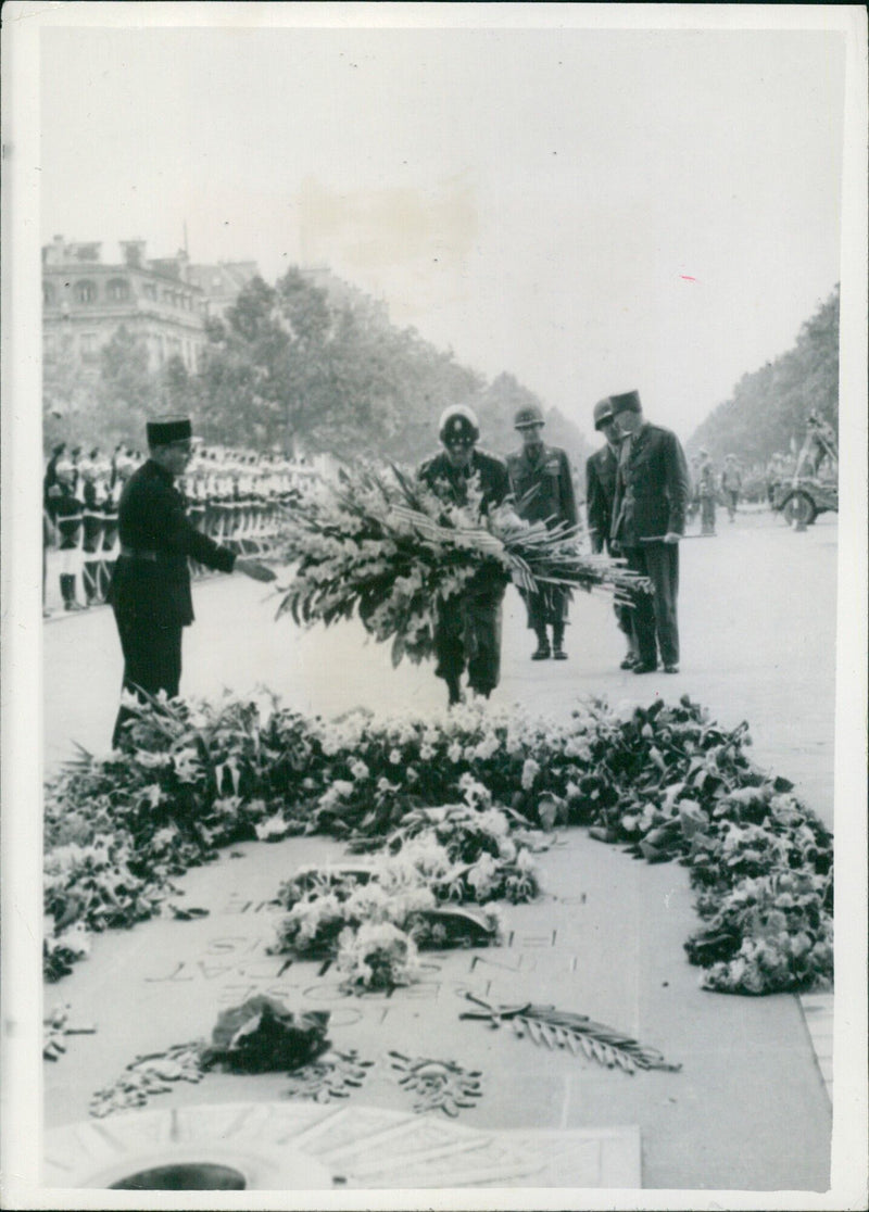 Lieutenant General Omar N. Bradley pays tribute to France's Unknown Warrior at the Arc de Triomphe in Paris following the city's liberation from Nazi domination. - Vintage Photograph