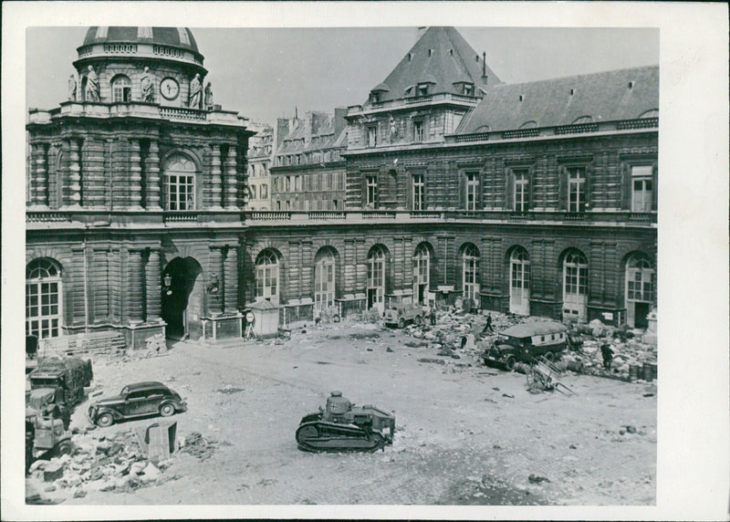 On August 25, 1944, the courtyard of Luxembourg Palace was filled with German military vehicles and personal belongings abandoned by Nazi officers during the liberation of Paris. Photo: U.S. Signal Corps TO-HQ-44-12918. - Vintage Photograph