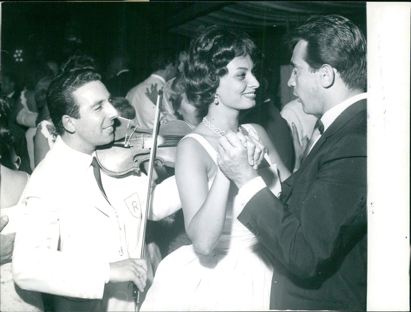 Sophia Loren attends a party in her honor with Walter Chiari - Vintage Photograph