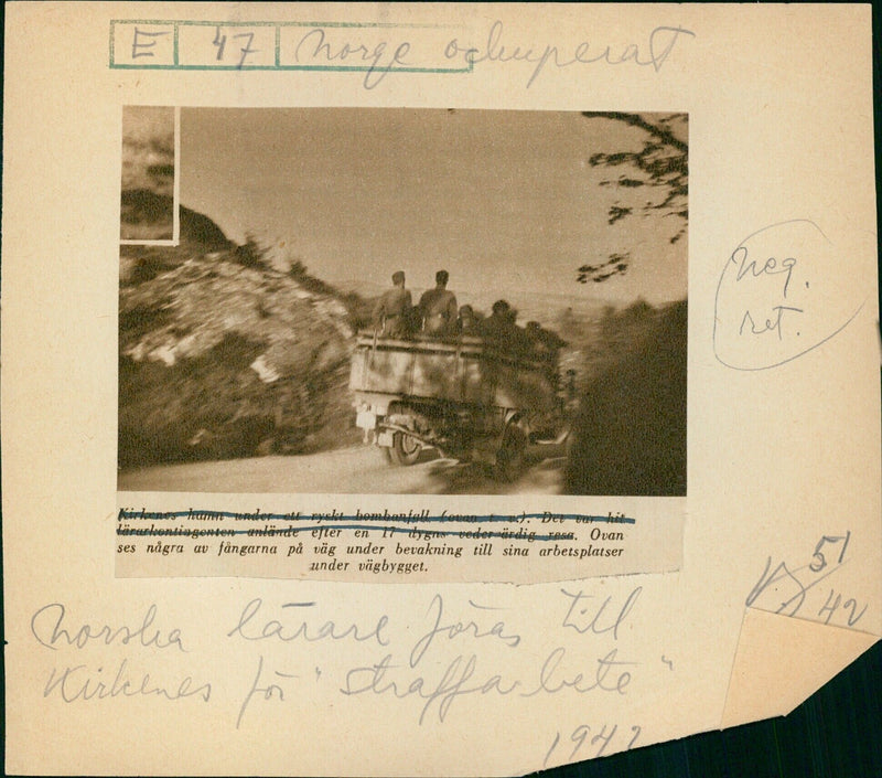 Prisoners on their way to their workplaces during road construction in Kirkenes harbor after a Russian bombing raid - Vintage Photograph