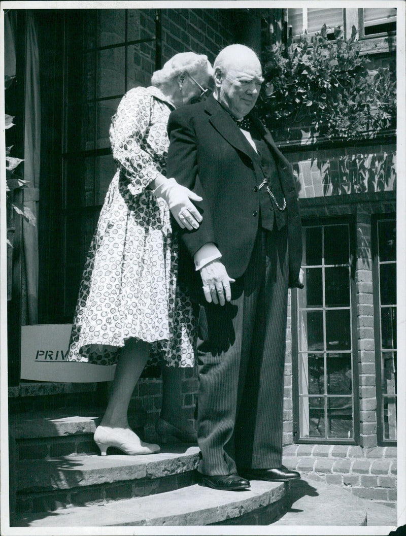 Sir Winston steps into the sun with Lady Churchill's help - Vintage Photograph