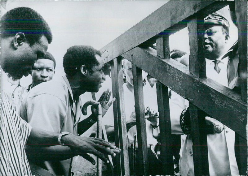 Ghana's Minister of Finance and Trade talks to a Togolese Police Commissioner at the frontier post between Ghana and Togo - Vintage Photograph