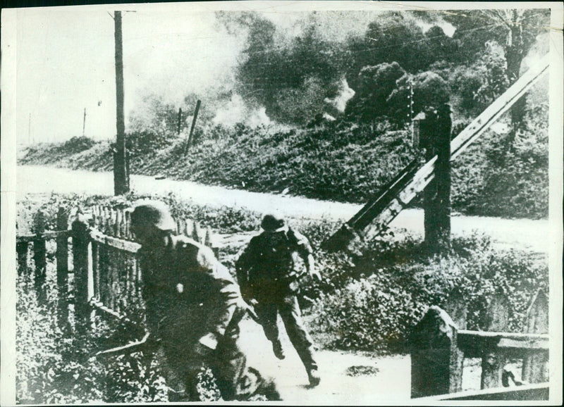 Two German soldiers dash for safety from an oil well explosion - Vintage Photograph