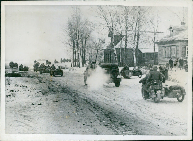 Russian combat vehicles passing farm - Vintage Photograph