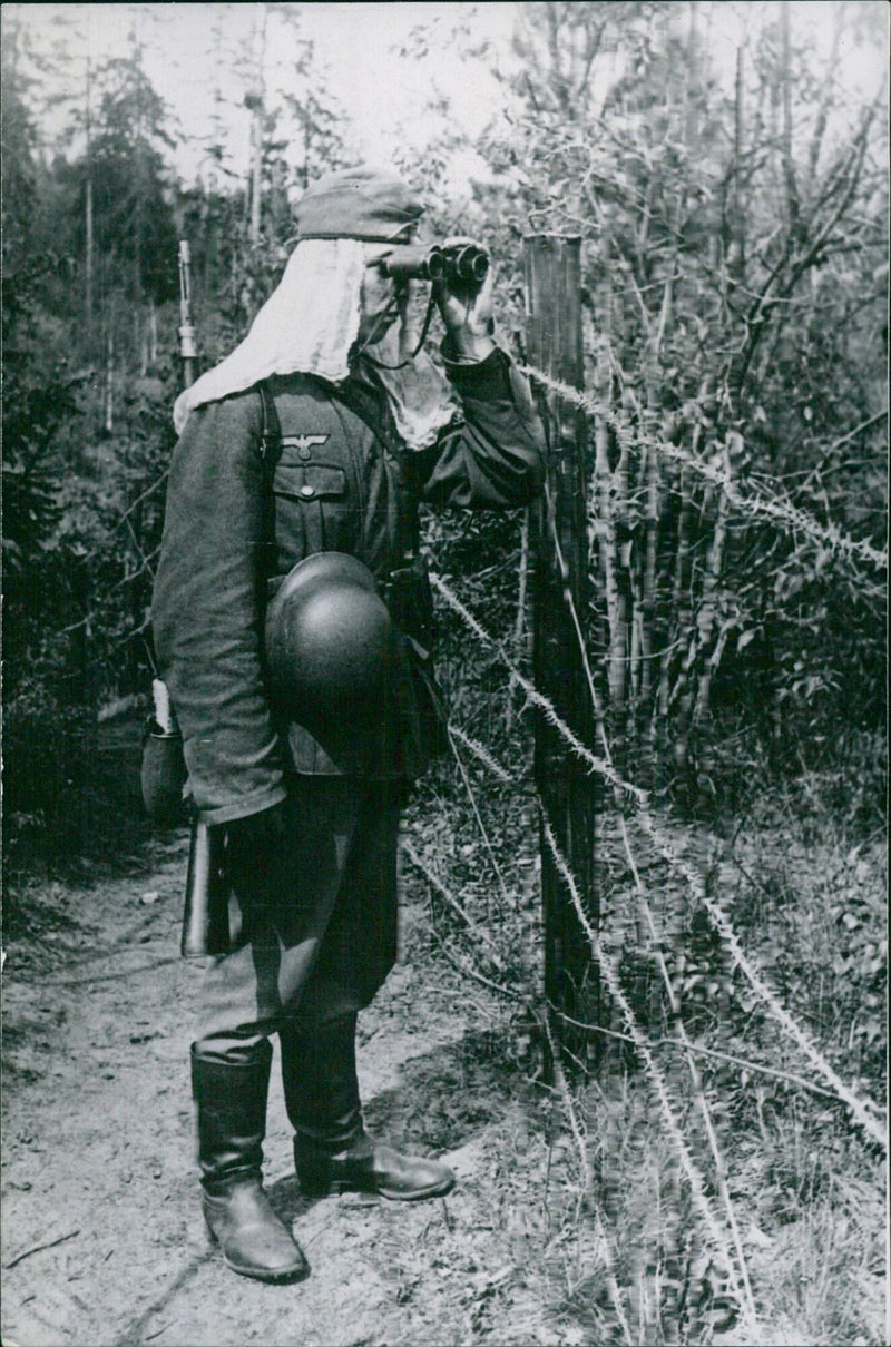 German soldier at barbed wire fence - Vintage Photograph