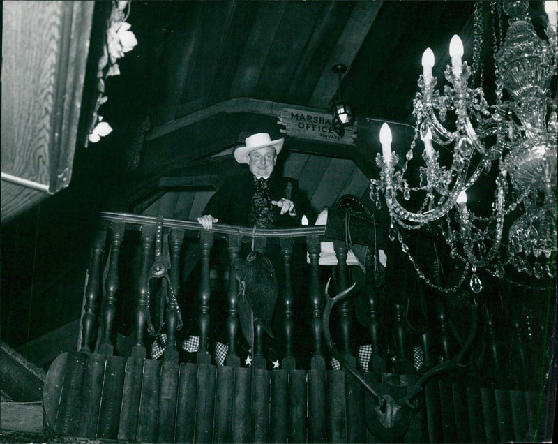 Deputy Marshal Bob Patience surveys customers in Tombstone, Arizona - Vintage Photograph