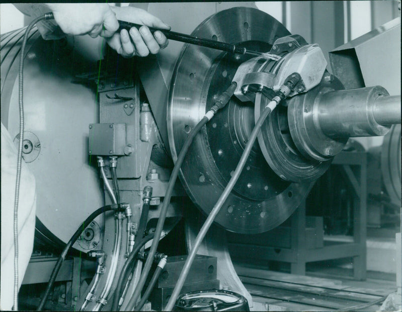 Taking a temperature reading on a disc brake - Vintage Photograph