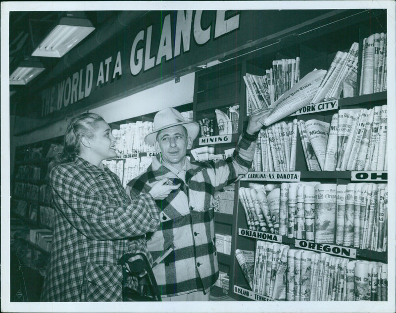 A woman buys a newspaper - Vintage Photograph