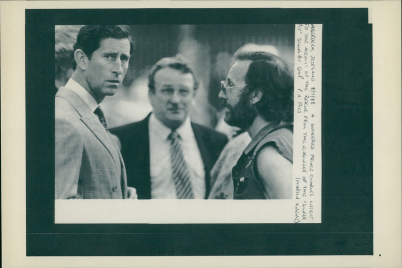 Prince Charles with a rescue man talking to him. - Vintage Photograph