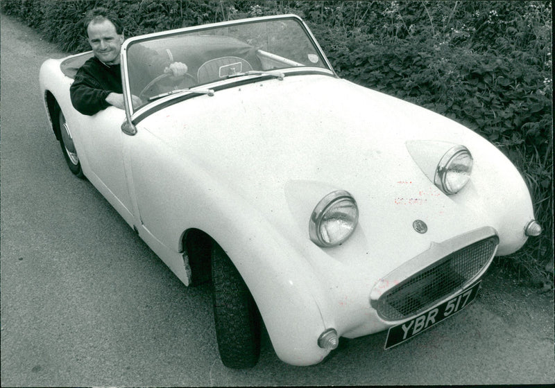 Michael Pentland at the wheel of his frog-eye sprite. - Vintage Photograph