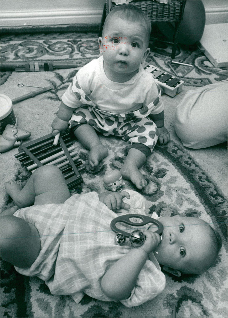 Melissa Martin, top, and Hannah Langlands try out some musical instruments. - Vintage Photograph