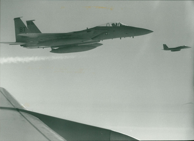 Two F15 Eagles wait off the wing of the Stratotanker. - Vintage Photograph