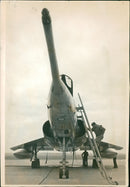 ONE of the crew of the french mirage IV jet seen leaving the aircraft at R.A.F. marham yesterday - Vintage Photograph