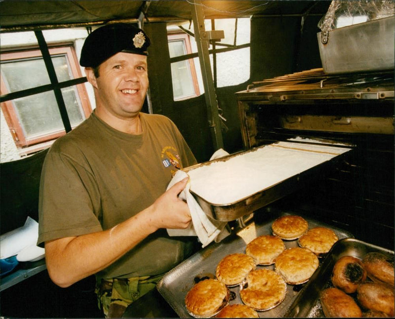 Sergeant Damon Scaife prepares the evening meal. - Vintage Photograph
