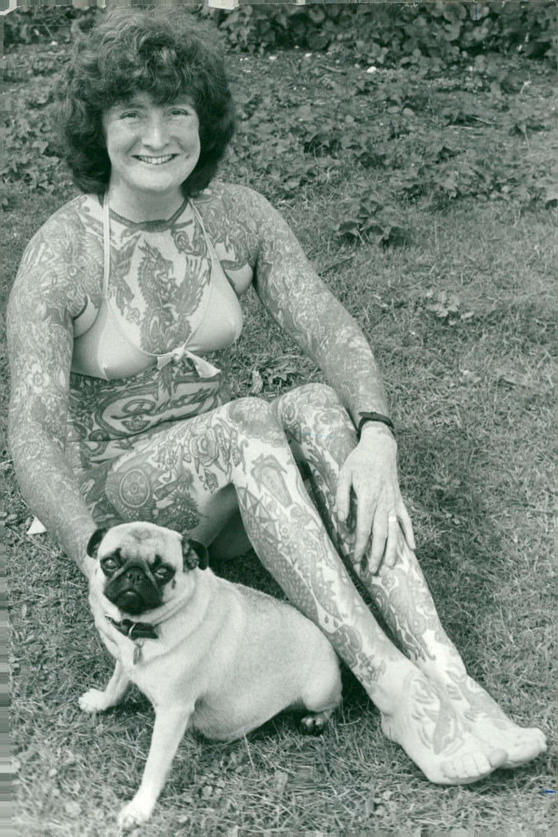 Mrs. Rusty Skuse of Snetterton, Britain's most tattooed woman, poses with her pet pug "Diddy." - Vintage Photograph