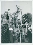 Queen Elizabeth climbs down with a ladder from riding an elephant - Vintage Photograph