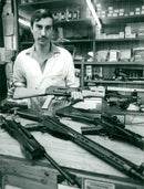 Weapons: Tony Buckland holding a Kalashnikov rifle Ak47 - Vintage Photograph