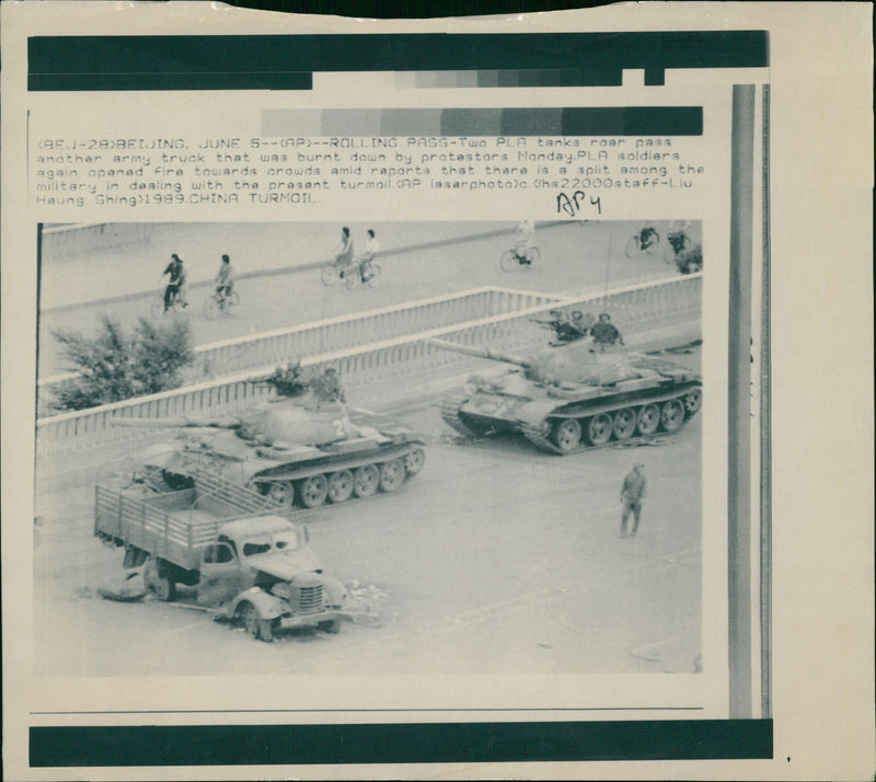 Two PLA tanks roar pass another army. - Vintage Photograph