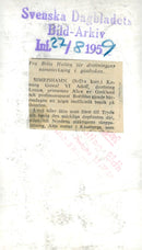 King Gustaf VI Adolf and Queen Louise write their signature in the guestbook that Brita HultÃ©n holds. - Vintage Photograph