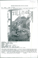 A Chinese People's Liberation Army soldier pretends he is a machine gunner. - Vintage Photograph