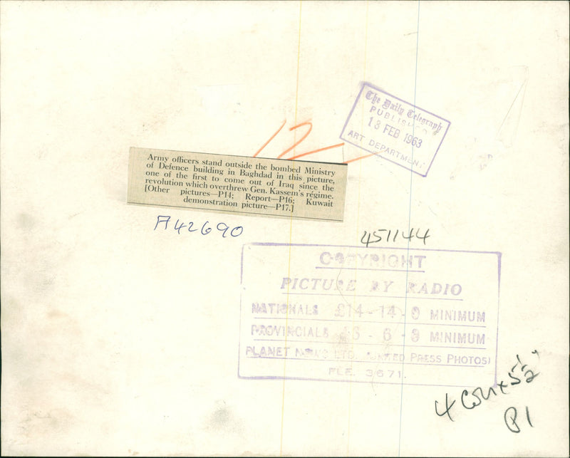 Army officers stand outside the bombed Ministry of Defense building. - Vintage Photograph