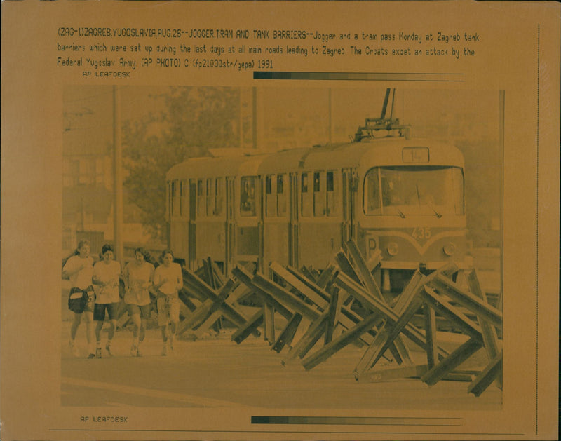 Jogger and a tram pass at Zagreb tank barriers - Vintage Photograph