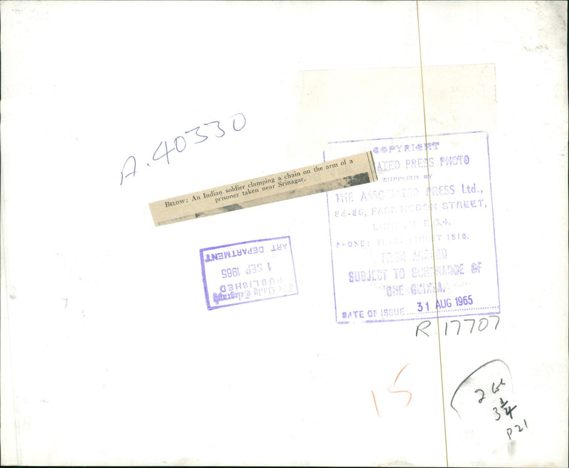 AN INDIAN SOLDIER CLAMPING A CHAIN ON THE ARM OF A PRISONER. - Vintage Photograph