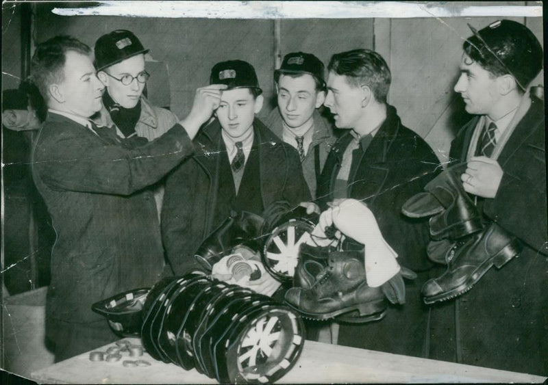 Youths of 18 who have been called to the mines are fitted with safety helmets. - Vintage Photograph